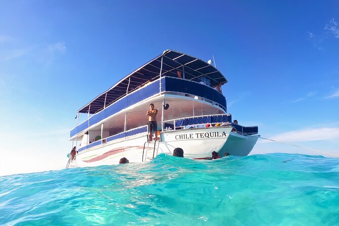 Cozumel Catamaran Tour: Snorkel at Top Reefs & Open Bar - Board the Double-Deck Boat: Open Bar, Entertainers, and the Soundtrack